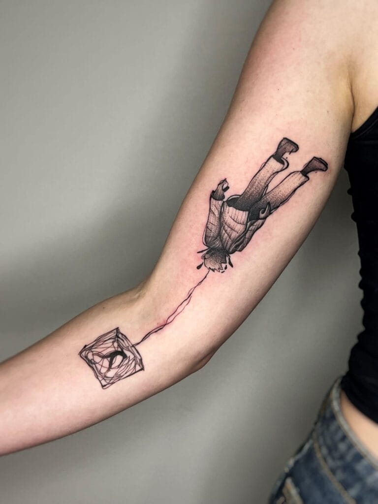 A tattoo depicting a person plummeting from the sky, capturing a moment of freefall and dramatic motion.