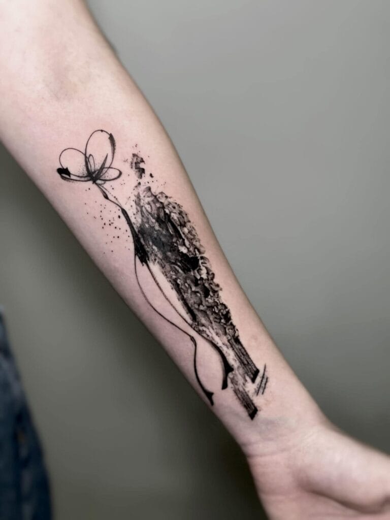 A tattoo of a woman with a beautiful flower design inked on her arm, showcasing artistry and personal expression.