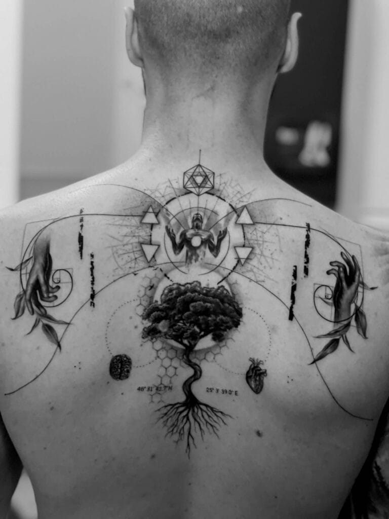A man showcasing intricate tattoos on his back and chest, highlighting his unique body art and personal style.
