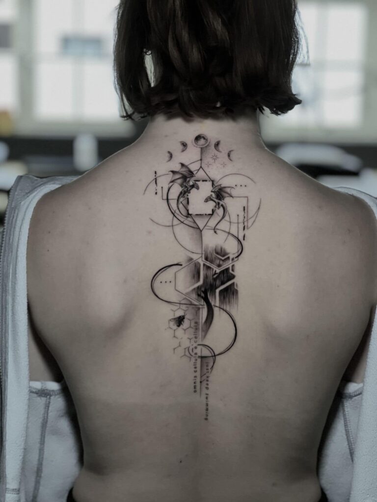 A woman showing off a tattoo on her back, highlighting intricate designs and vibrant colors.