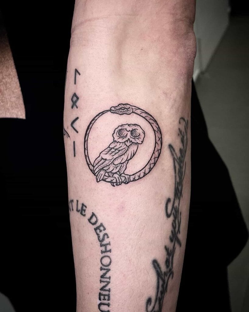 Tattoo of a detailed owl perched on an arm, showcasing intricate designs.