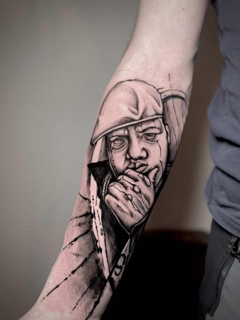 A tattoo depicting a man casually smoking a cigarette, showcasing intricate details and a bold design.
