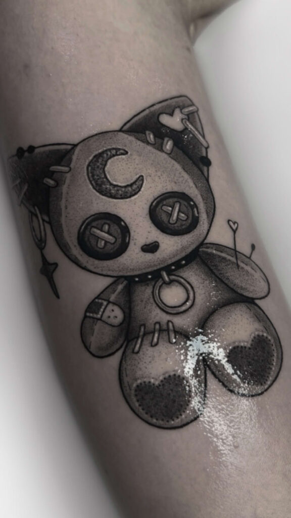 Surreal black & grey tattoo art featuring a flower with a human face, emerging from a stitched vase, a custom illustrative design by Achlys.